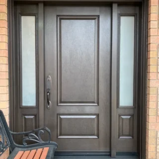 Single entry door with sidelights installed on a residential brick home