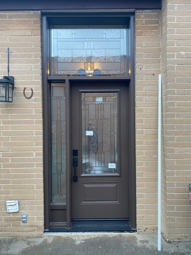 Brown entry door installation in Oshawa with decorative glass, matching sidelight and transom window